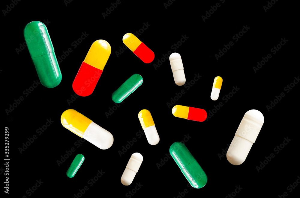 Medical pills fly on a black background. Levitation. Medical pills fly on a black background. Levitation.