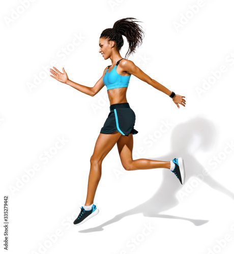Smiling young girl runner in silhouette. Photo of african american girl in fashionable sportswear on white background. Dynamic movement. Side view. Full length. Sports and healthy lifestyle