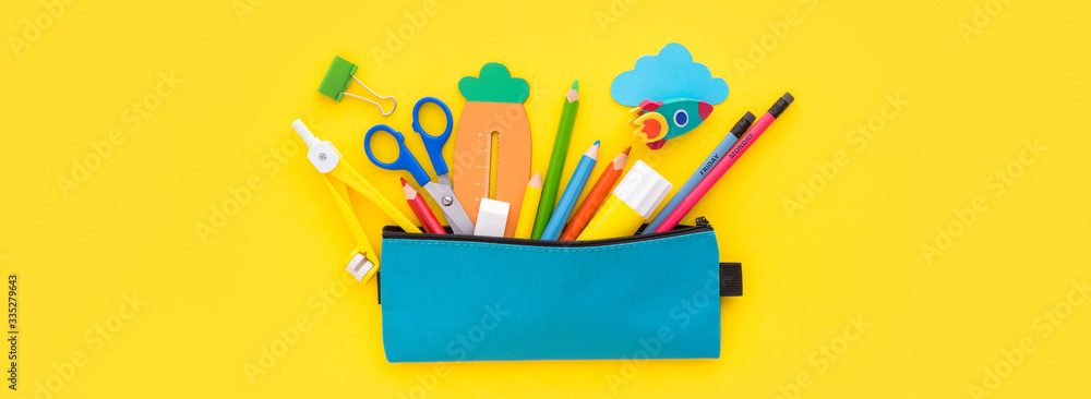Pencil case and school supplies inside on yellow background. Back to school creative flat lay.    - obrazy, fototapety, plakaty 