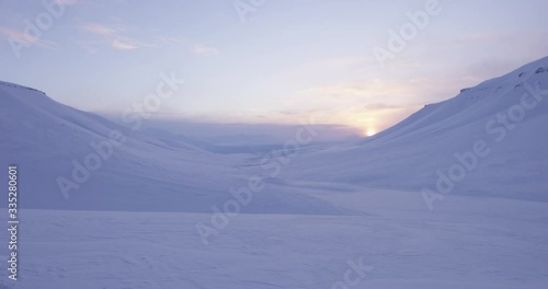 Sunset Shot infront of Snowmountains in Svalbard. photo