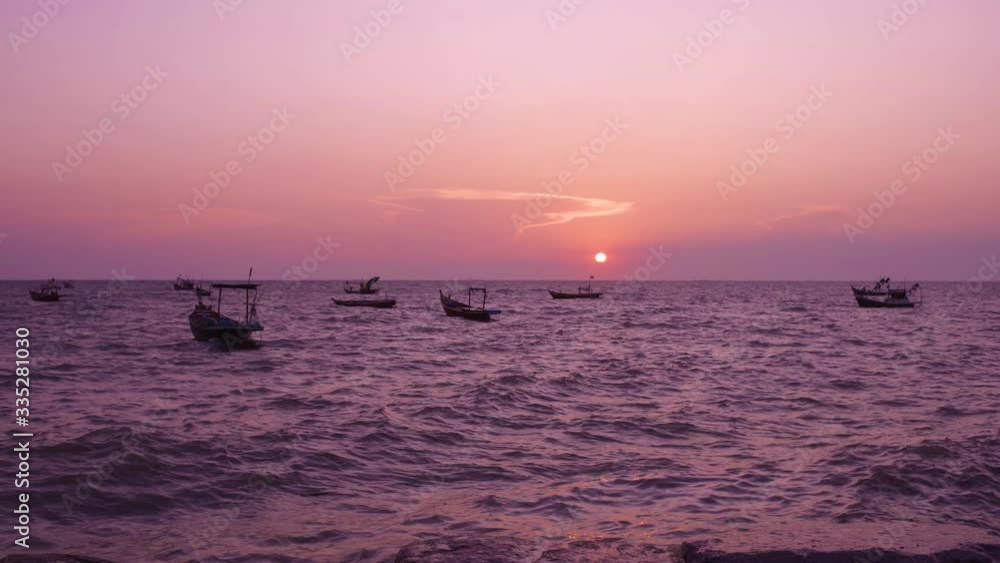 Silhouette fishing boat floating on water with color sky before sunset Silhouette fishing boat floating on water with color sky before sunset