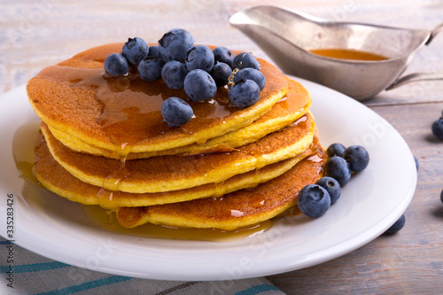 mouth-watering pancakes with blueberries, blackberries and maple syrup