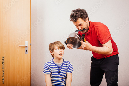 Parent cutting hair at home during 2020 pandemic crisis photo