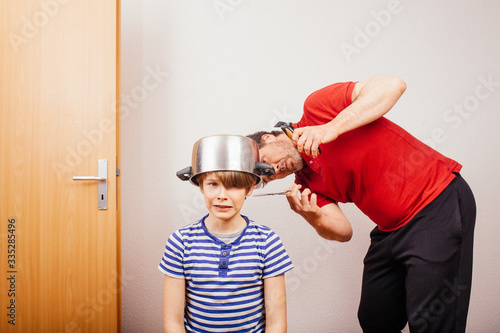 Parent cutting hair at home during 2020 pandemic crisis photo