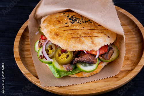 Pieces of beef fried on a trochanter with parsley and dill with pickles in a tortilla cooked in tandem photo