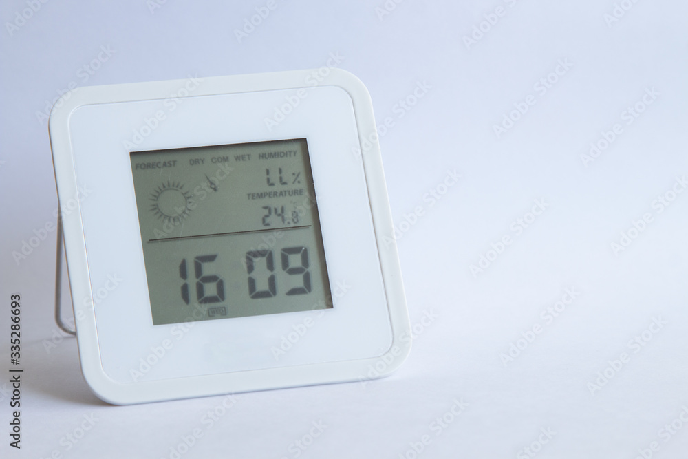 electronic clock thermometer hygrometer on a white background. copyspace for text electronic clock thermometer hygrometer on a white background. copyspace for text