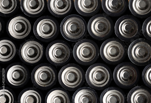 Batteries, top view, rows of alkaline battery AA size format. Energy abstract background