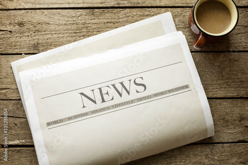 Tableau sur toile Newspaper and coffee on wooden background