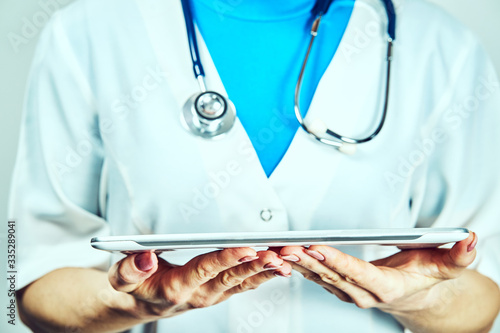 Doctor working on a digital tablet with copy space photo