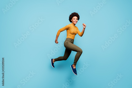 Full length body size view of nice lovely healthy cheerful active confident strong wavy-haired girl running having fun isolated on bright vivid shine vibrant blue green teal turquoise color background