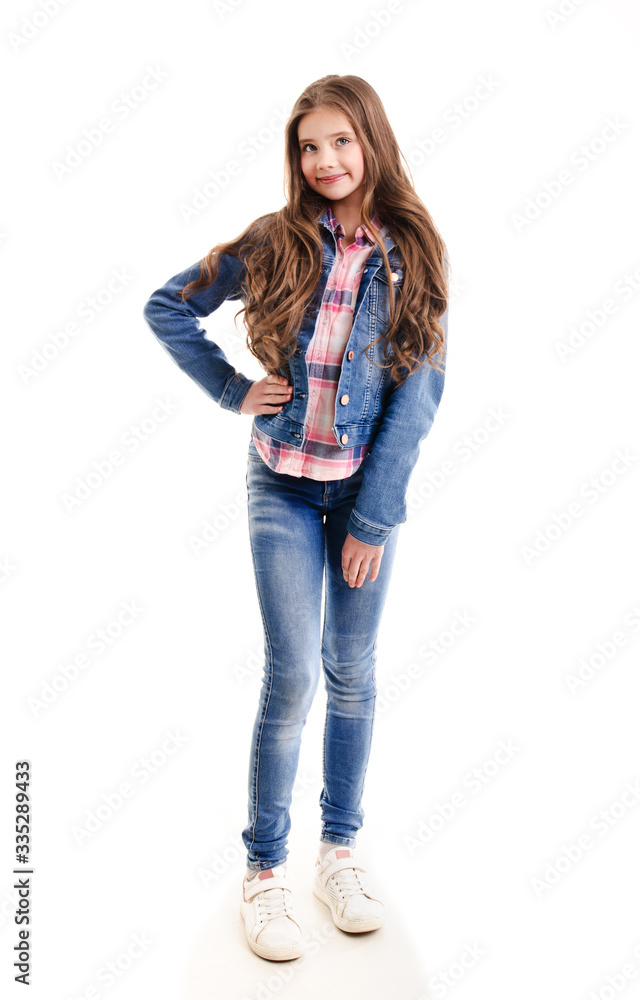 Portrait of adorable smiling little girl child preteen standing in jeans isolated Portrait of adorable smiling little girl child preteen standing in jeans isolated