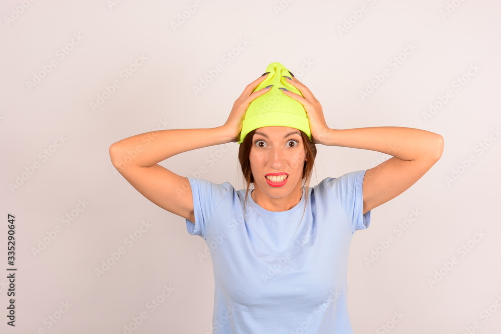 woman in yellow hat clings to her head woman in yellow hat clings to her head