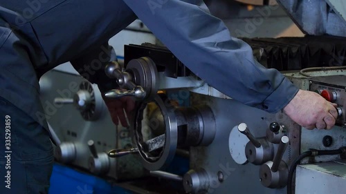 The master works on a machine at a factory in Russia