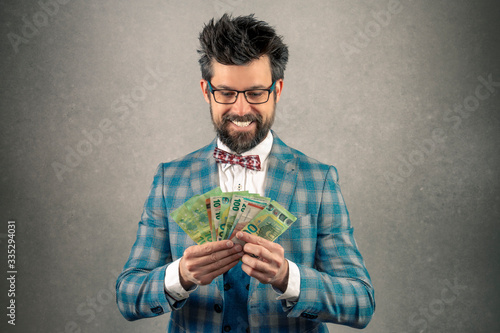 Greedy businessman looking the money in his hand