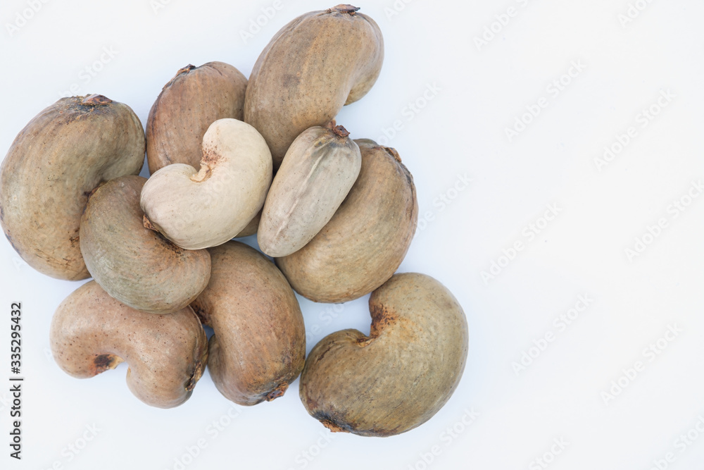 Cashew nuts with shell waiting to be processed on white background Cashew nuts with shell waiting to be processed on white background