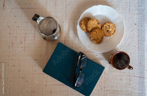 reading a book with coffee and cookies
