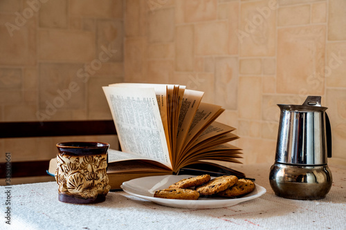 reading a book with coffee and cookies