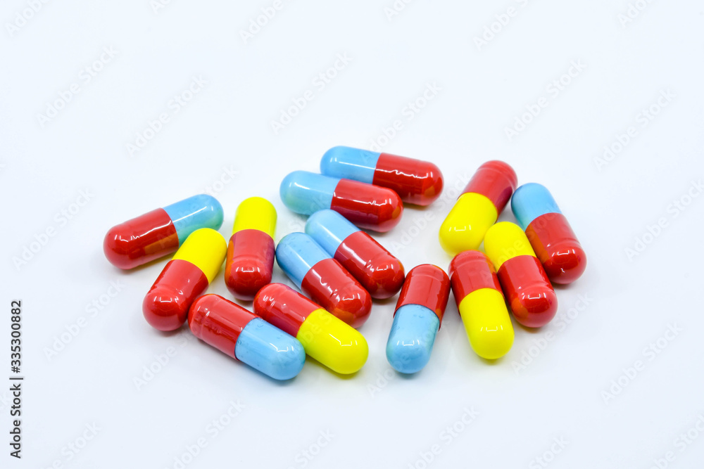 Coloured capsules of cold and flu medication on a plain white background Coloured capsules of cold and flu medication on a plain white background