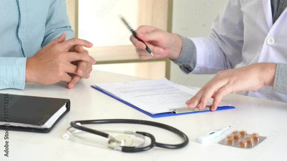 4k video of doctor working with patient taking notes with clipboard and discussing something in his medical office, health care and people concept. 4k video of doctor working with patient taking notes with clipboard and discussing something in his medical office, health care and people concept.
