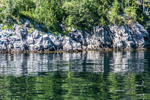 Fototapeta Naklejka Na Ścianę i Meble -  Typical scandinavian rocks and green water
