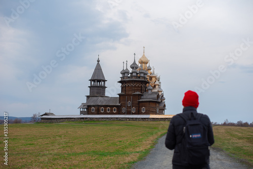 A girl watching at Kizhi wooden cathedral in Karelia, Russia