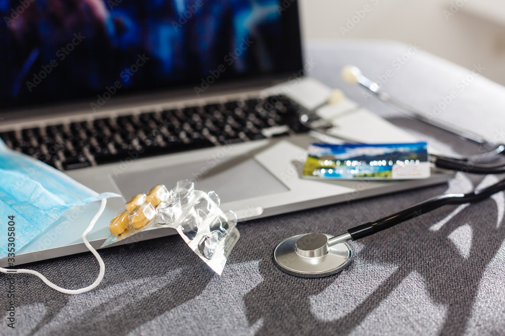 Pills spilled over a keyboard of a laptop computer Pills spilled over a keyboard of a laptop computer