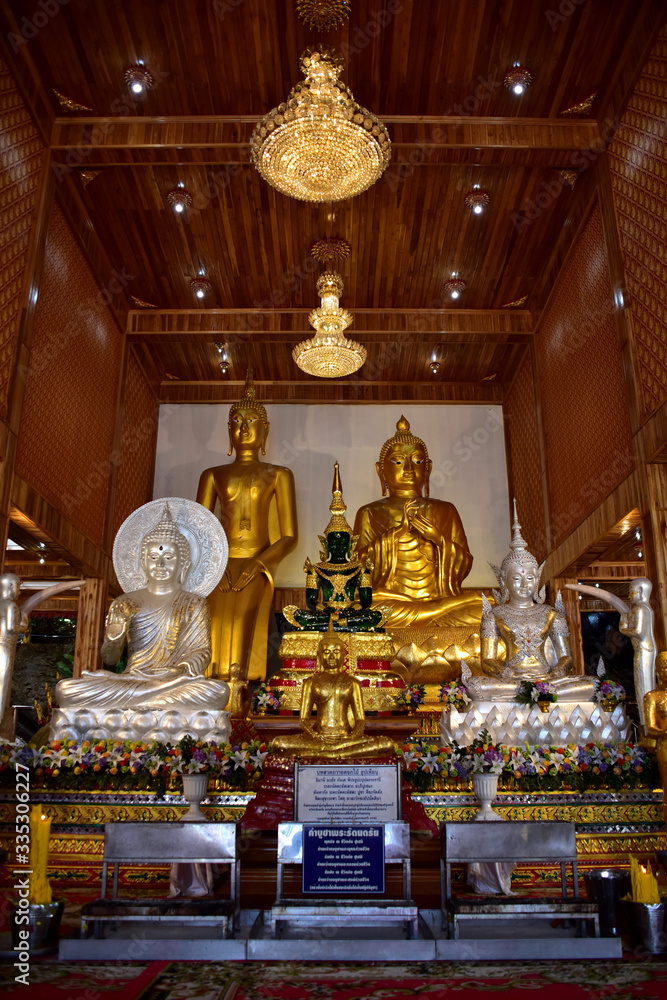 Golden statue of buddha in temple, Thailand	