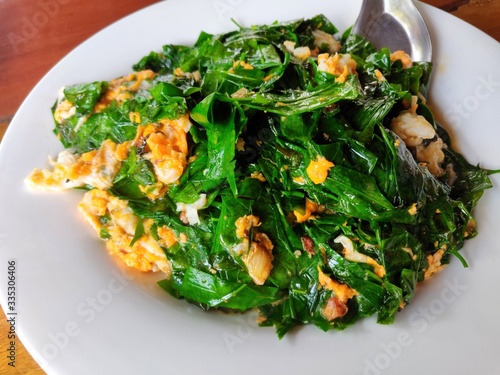 Stir-fried Malindjo leaves with Egg (Bai Lieng Pad Kai) photo