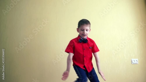 A preschool boy European is having fun at home dancing Fortnite. Dance challenge photo