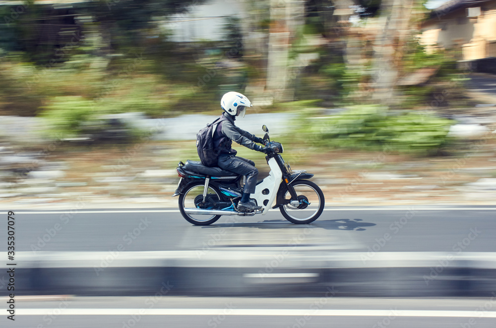Fast moving moped with panning technique Fast moving moped with panning technique