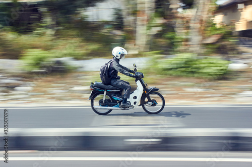 Photos Fast moving moped with panning technique