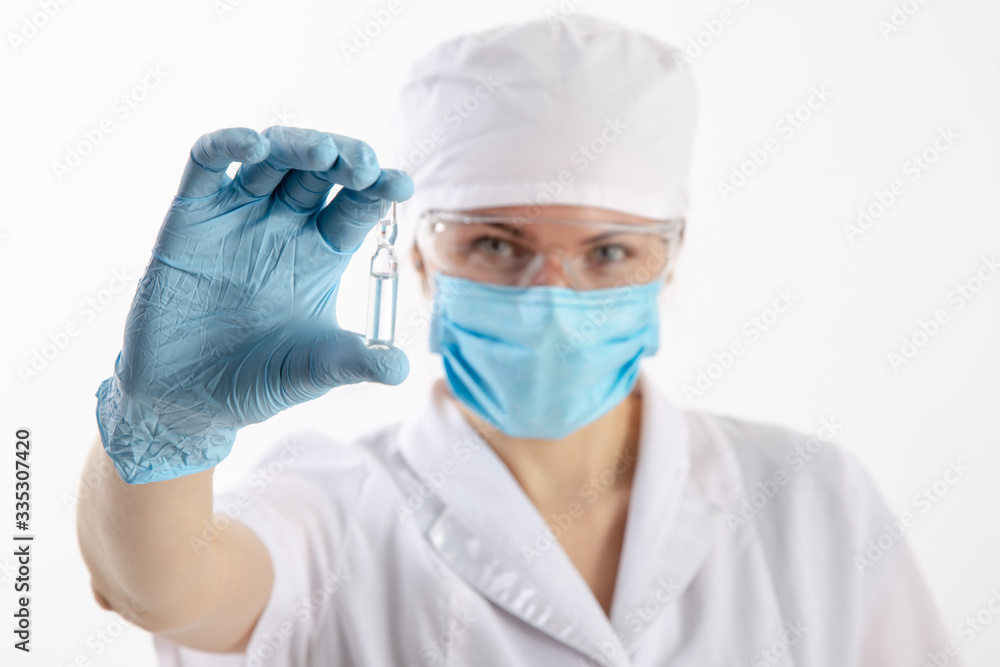 A doctor in a white coat looks at the medication. A doctor in a white coat looks at the medication.