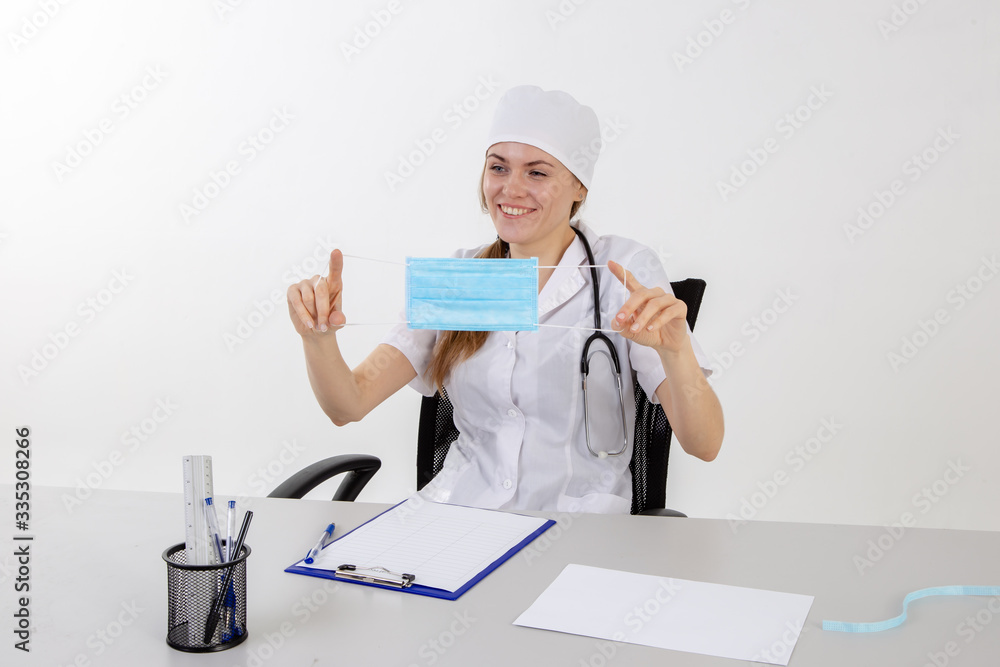 The doctor in a white coat puts on a mask. The doctor in a white coat puts on a mask.
