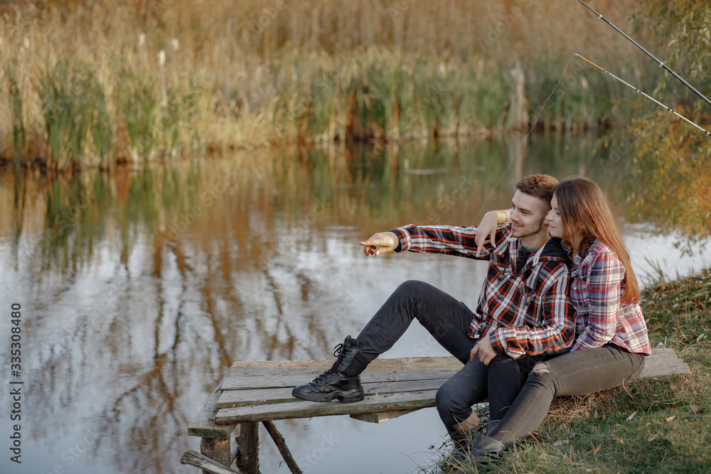 Couple by the river. Guy in a red shirt. Man in a fishing. Couple by the river. Guy in a red shirt. Man in a fishing.