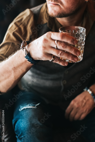 Man holding a glass of whisky. place for text. Close up.