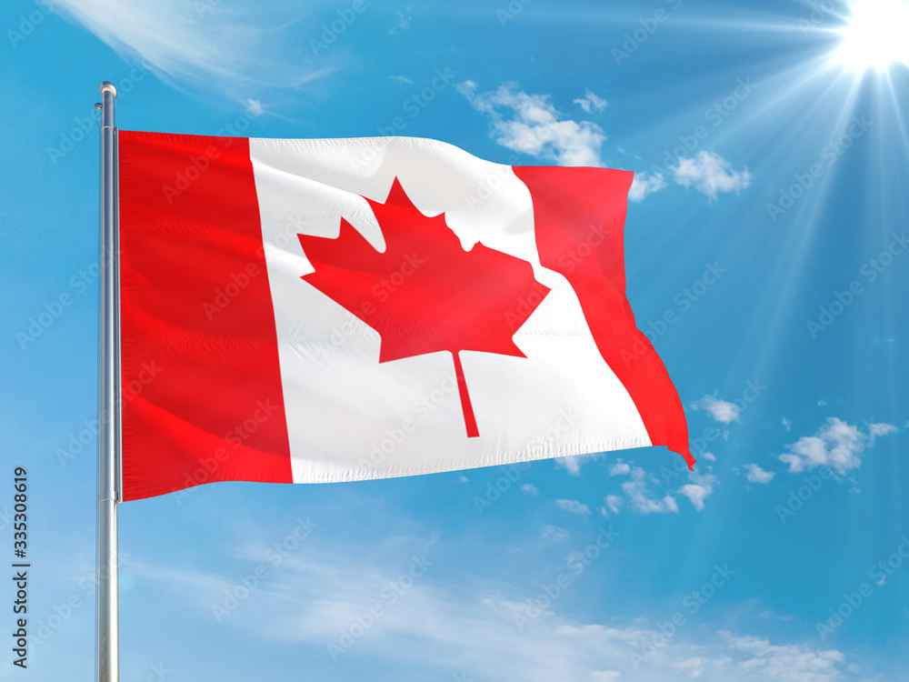 Canada national flag waving in the wind against deep blue sky. High quality fabric. International relations concept. Canada national flag waving in the wind against deep blue sky. High quality fabric. International relations concept.