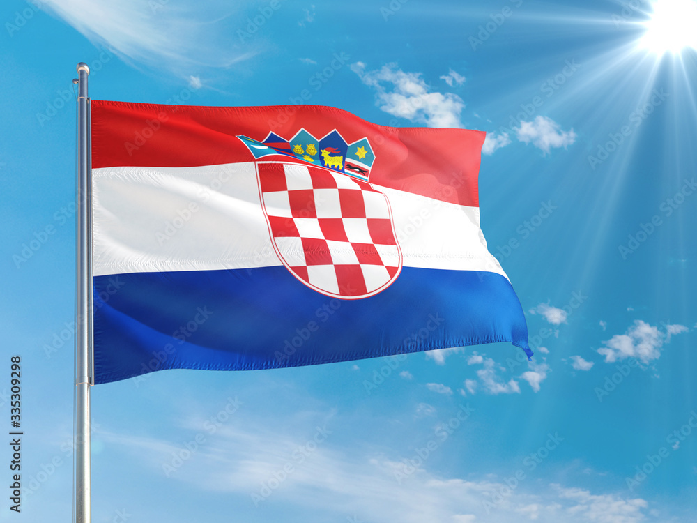 Naklejka premium Croatia national flag waving in the wind against deep blue sky. High quality fabric. International relations concept.