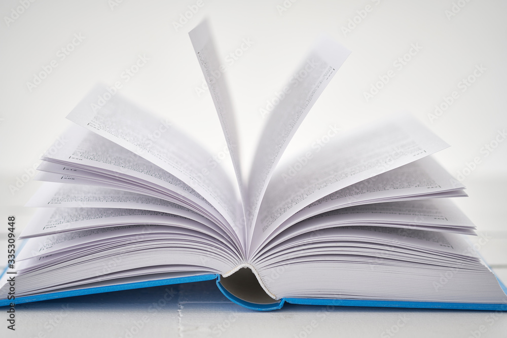 Opened blue book on white table. Low DOF Opened blue book on white table. Low DOF