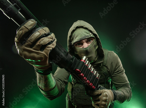 Photos mercenary soldier with a shotgun