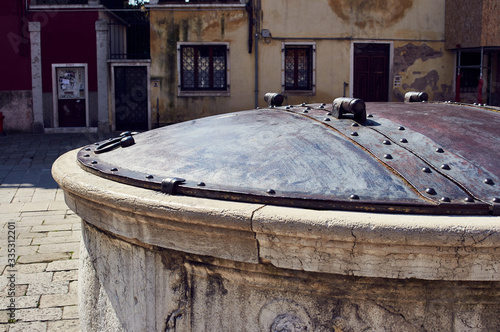 Old stone well with metal lid in Venice