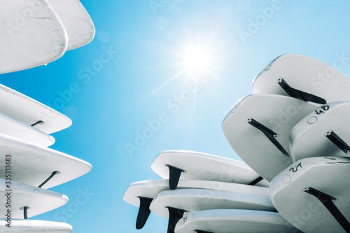 Konstfotografi White surfboards under  the bright sun  and blue sky