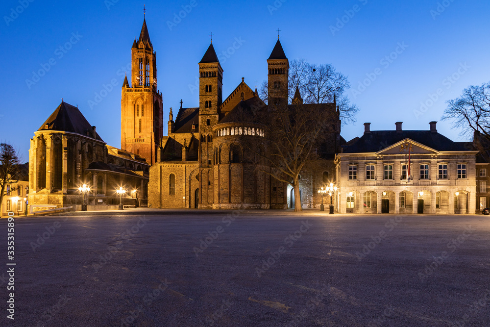 Unique view of a empty Vrijthof square and no people in downtown Maastricht during blue hour with the ancient churches and former military house