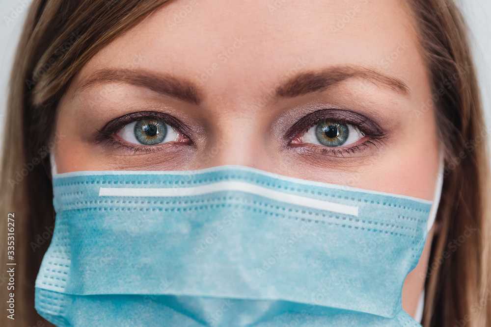Woman wearing protection medicine mask. Female face of medical staff close-up. Preventive gear against coronavirus Woman wearing protection medicine mask. Female face of medical staff close-up. Preventive gear against coronavirus