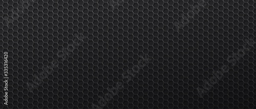 Black background with metal mesh with hexagonal cells