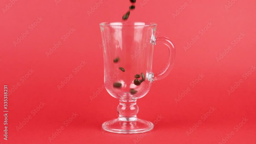 Coffee beans quickly pour, latte glass cup, red background. Pep concept Coffee beans quickly pour, latte glass cup, red background. Pep concept