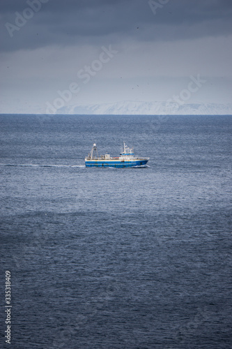 A lone fishing trawler somewhere south of Iceland in the Atlantic Ocean.