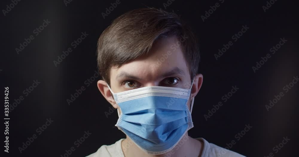 a man in a medical mask shows like and okay a man in a medical mask shows like and okay