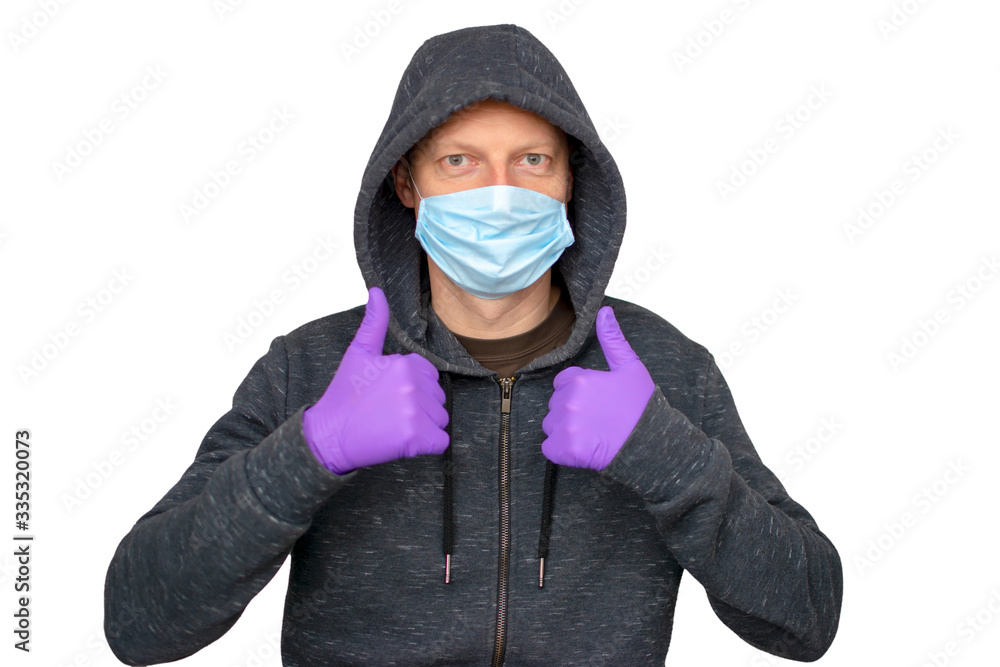 Caucasian man with beard protecting from the coronavirus with a mask and gloves over isolated background giving a thumbs up gesture Caucasian man with beard protecting from the coronavirus with a mask and gloves over isolated background giving a thumbs up gesture