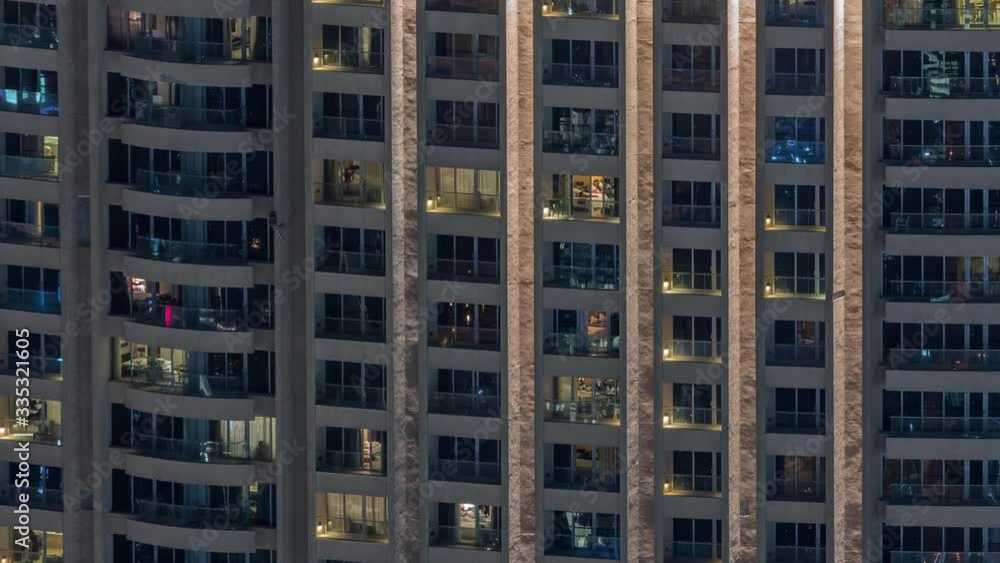 Night view of apartment building timelapse. High rise skyscraper with blinking windows with people moving inside. Aerial view from above Night view of apartment building timelapse. High rise skyscraper with blinking windows with people moving inside. Aerial view from above