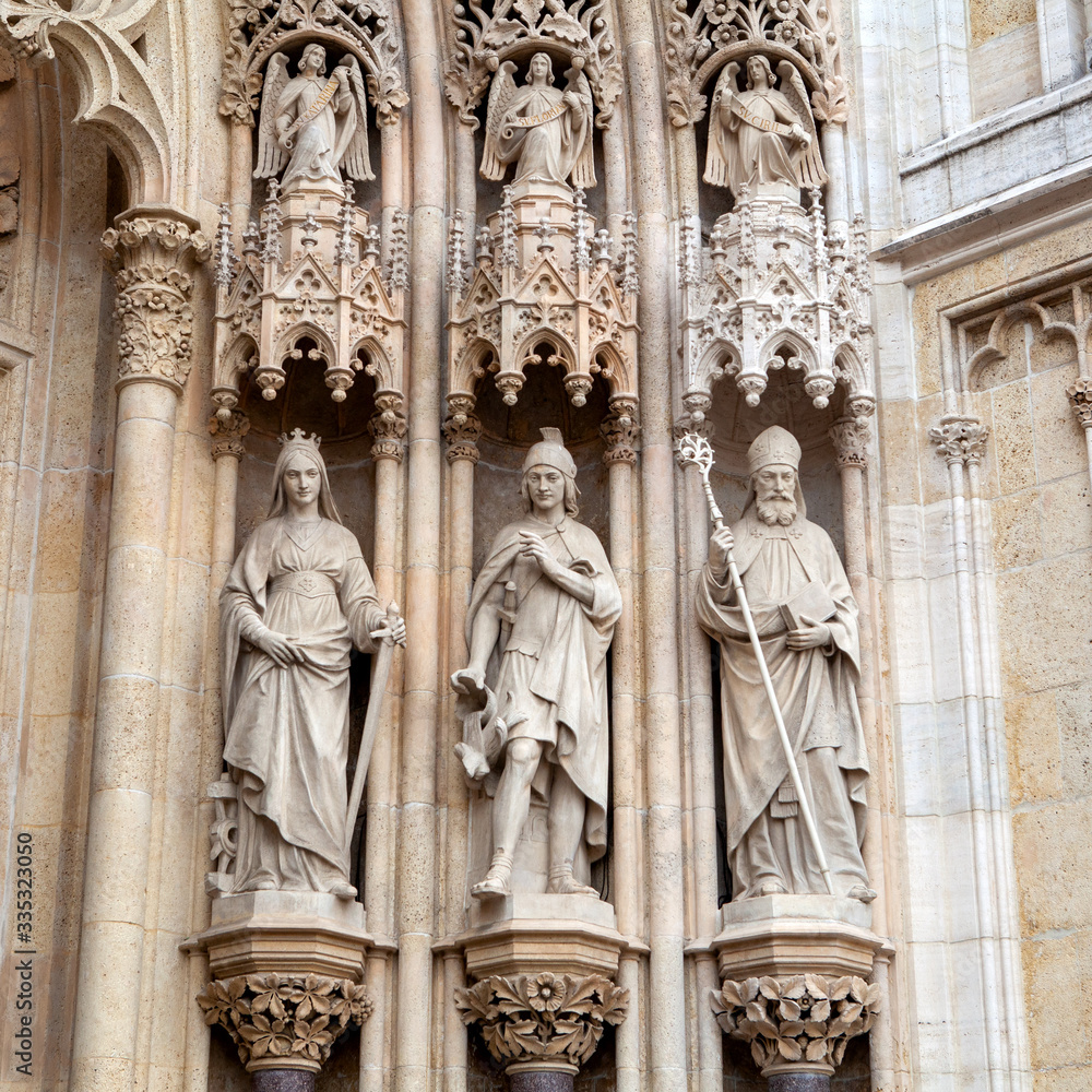 Sculptures of people on the ancient facade of the Church, Europe